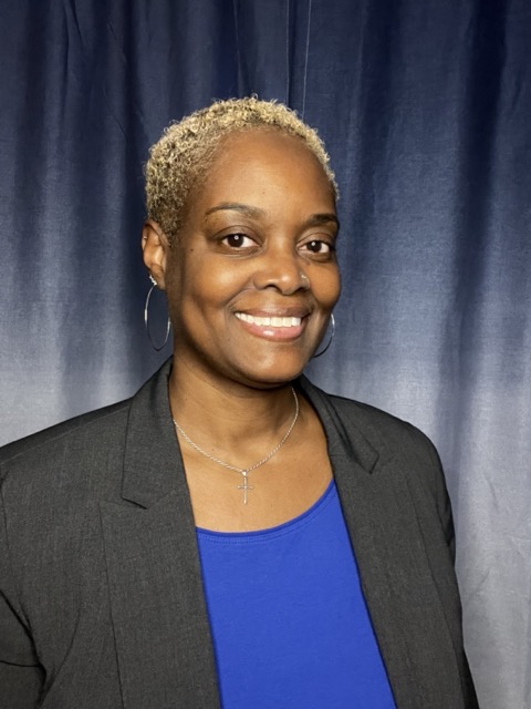 A woman in midlife with blonde, styled hair, radiating boldness and self-expression.