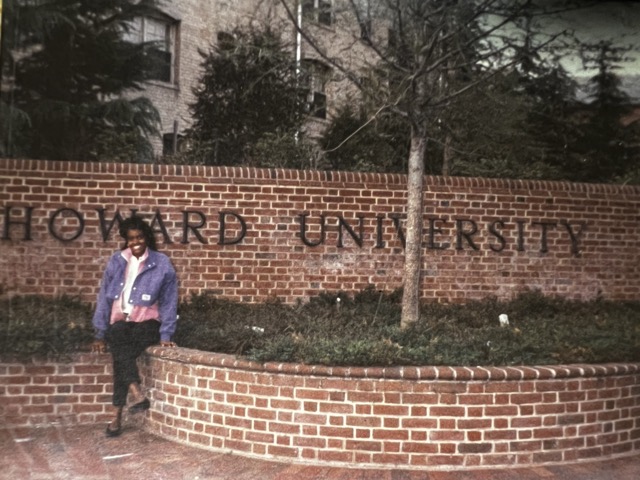 18-year-old freshman me sitting in front of the Howard University sign, full of hope and excitement for the journey ahead.
