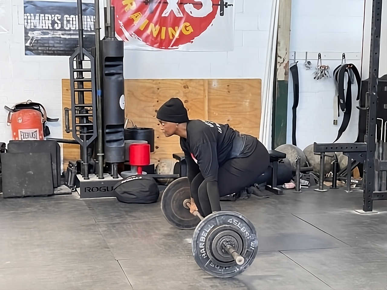 Tami Z. performing a deadlift, demonstrating strength, perseverance, and the power of faith-driven fitness."