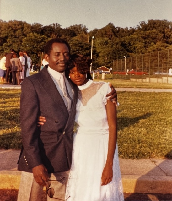 Zanele and her father at high school graduation ceremony.