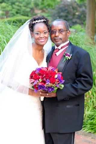 Zanele and her father on her wedding day, both smiling warmly at the camera.
