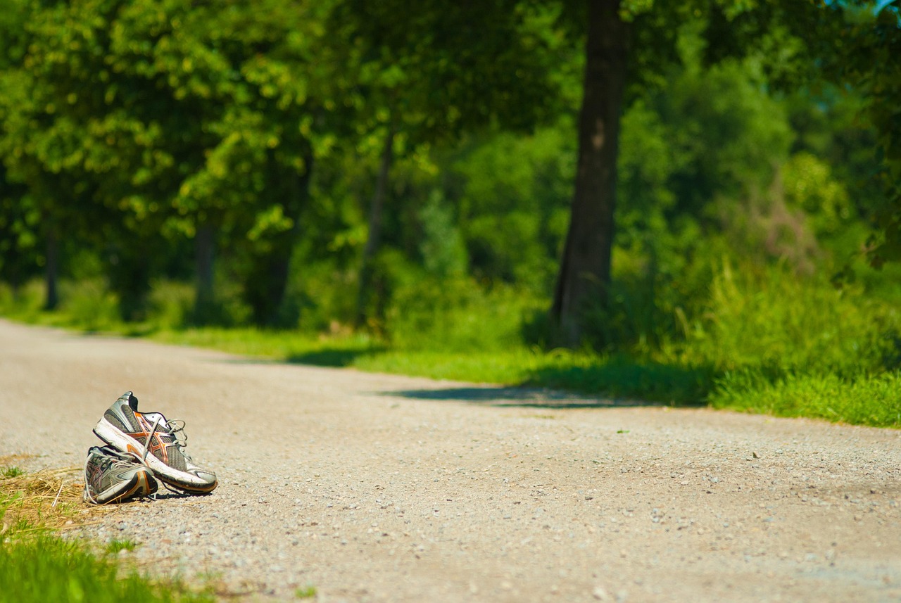 Walking shoes on gravel trail representing the importance of pacing in exercise